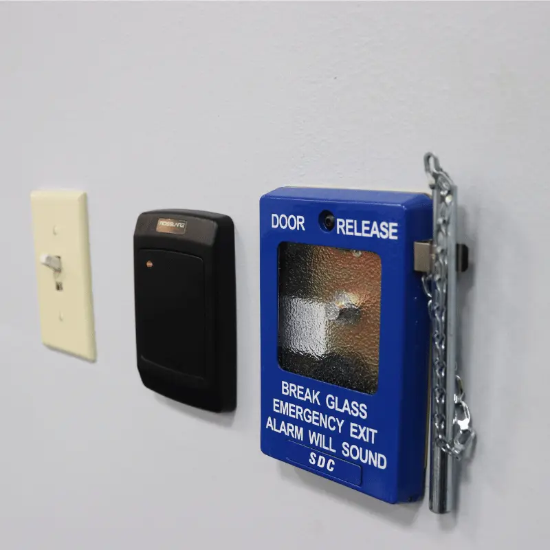 2M Technology installation of access card reader and emergency door release system on wall