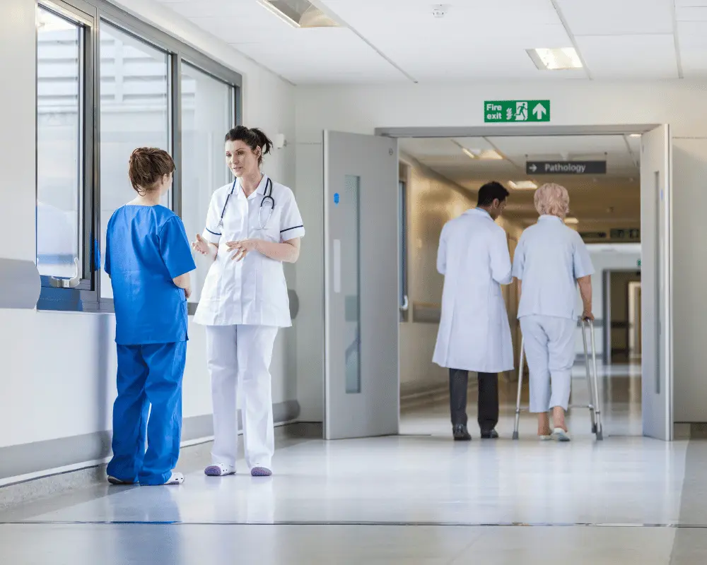 Doctor and nurse talking in the hallway of a hospital