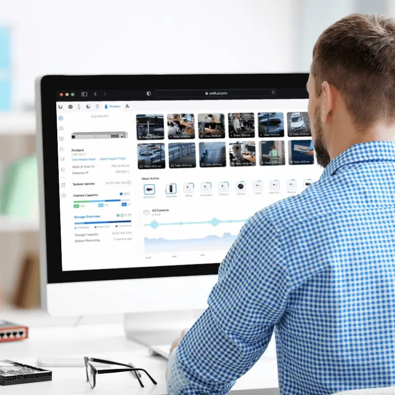 man watching camera feeds from Ubiquiti UniFi on a desktop computer