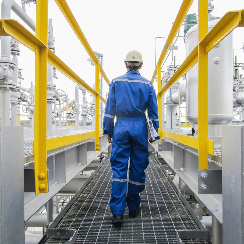 worker walking through refinery