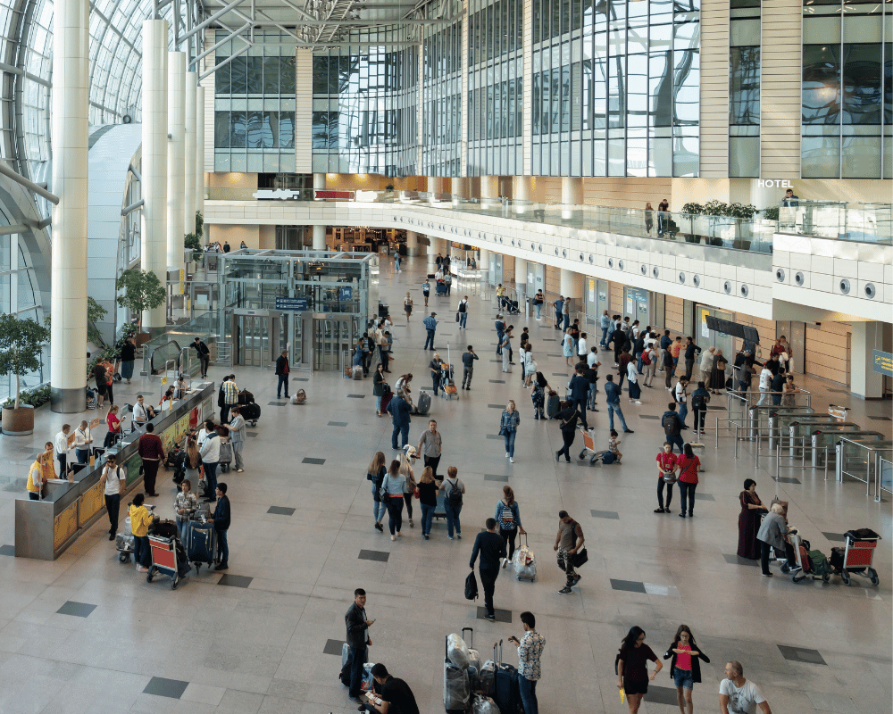 people walking through a busy airport terminal